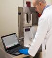 natoli engineering worker working on research and development for pill press machine